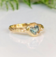 Unique Australian Sapphire ring in solid 14k gold, featuring a heart-shaped teal sapphire on a textured band.