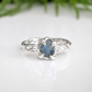 Raw Montana Sapphire silver ring with organic molten band, showcasing teal blue-green natural beauty.