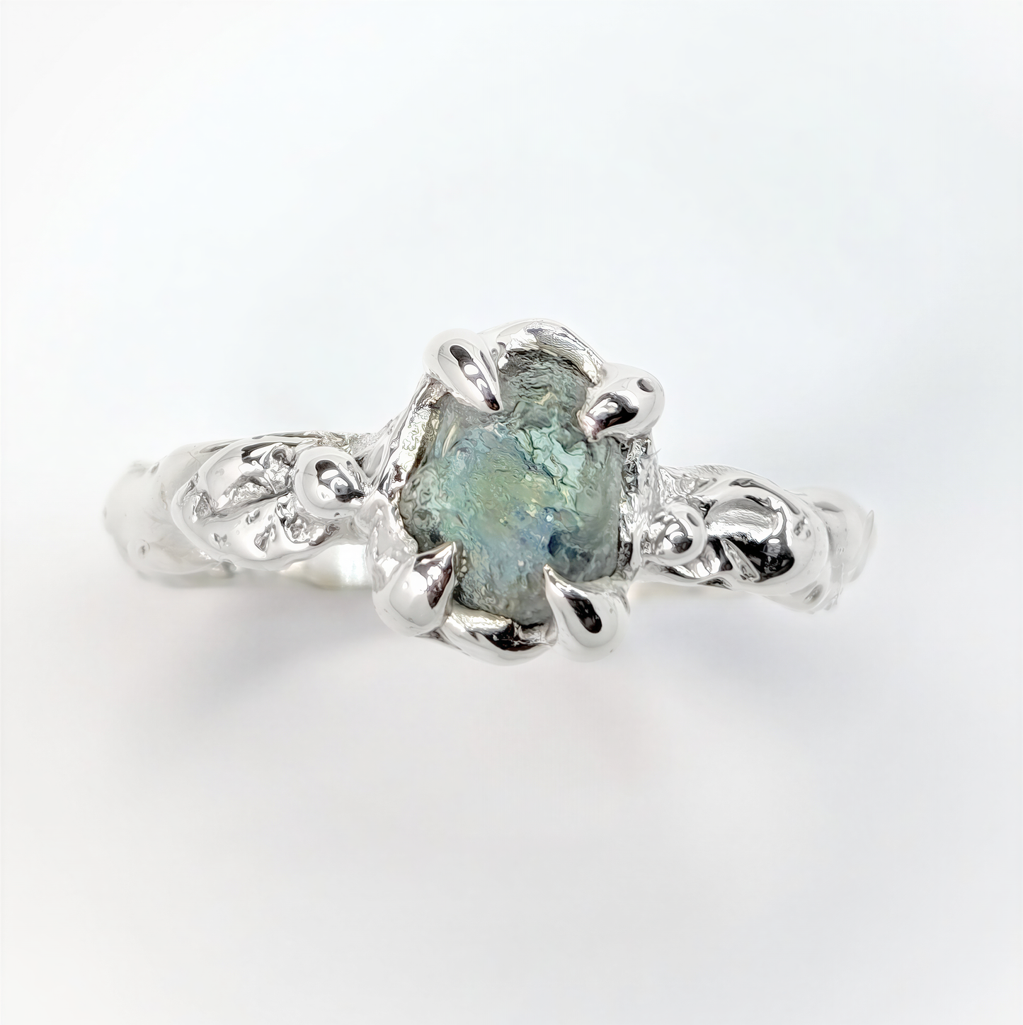 Natural teal-blue Montana Sapphire ring in Sterling Silver with textured molten band
