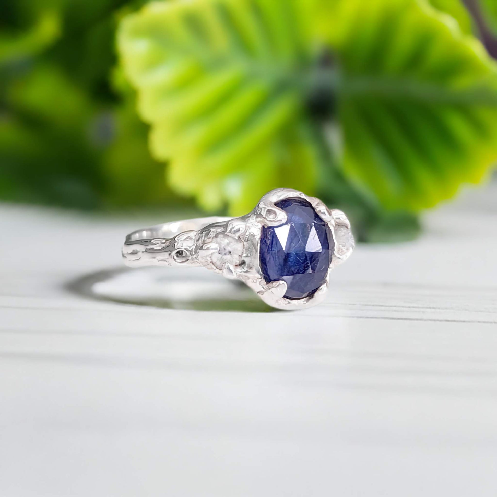Blue Sapphire and raw diamond engagement ring in solid sterling silver with a textured finish.