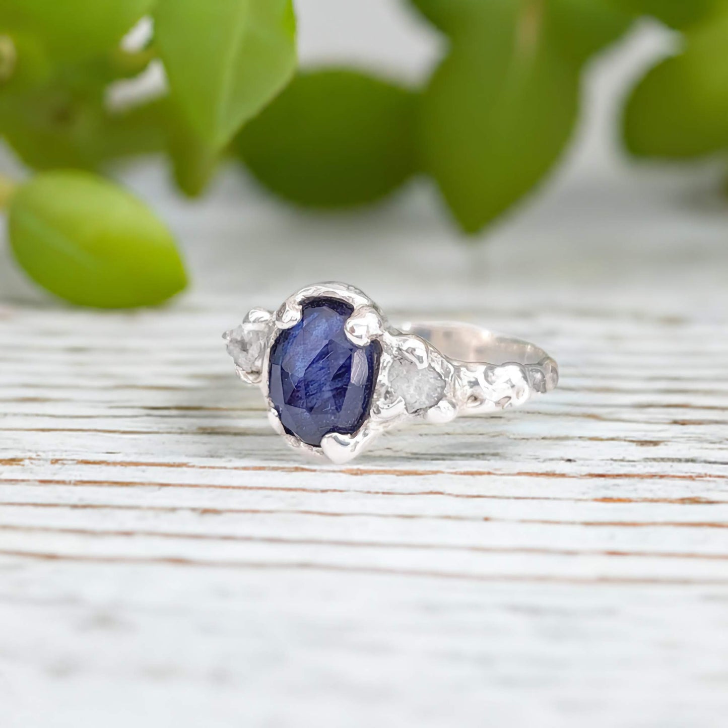 Blue Sapphire and raw diamond engagement ring in textured sterling silver, showcasing nature-inspired elegance.