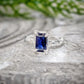 Emerald cut blue lab-created Sapphire engagement ring in solid 14k gold with organic texture.