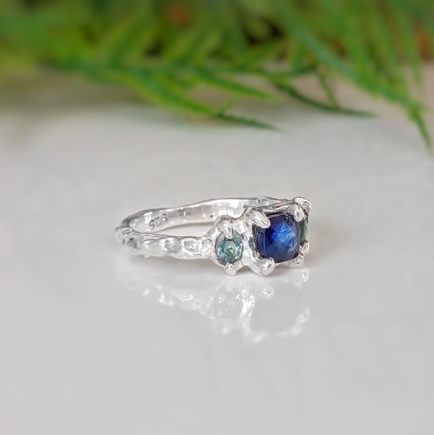 Elegant blue sapphire and teal tourmaline engagement ring in solid sterling silver, showcasing nature-inspired design.