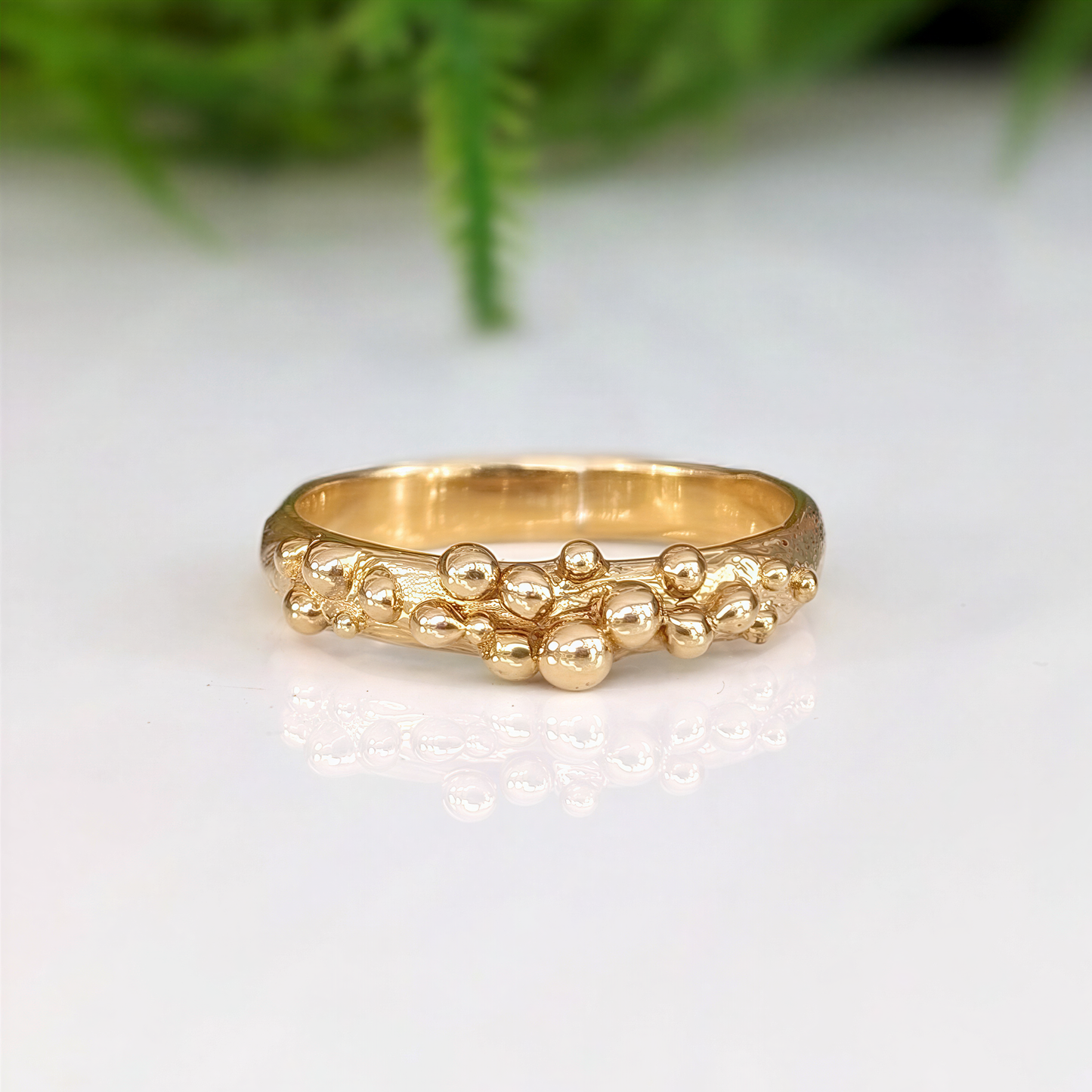Dew Drop beaded textured gold ring showcasing its unique handcrafted design and fluid metal form.