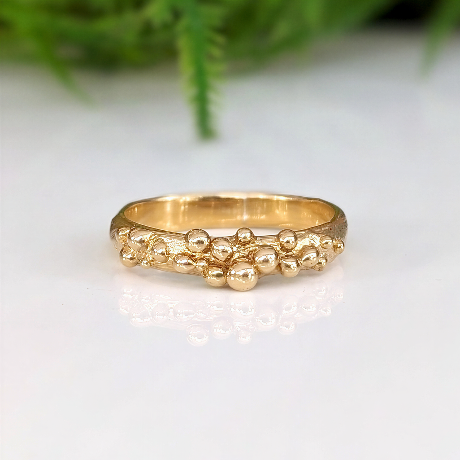 Dew Drop beaded textured gold ring showcasing its unique handcrafted design and fluid metal form.