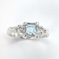 Handcrafted blue topaz engagement ring in sterling silver with organic textured band.