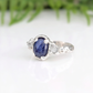 Rustic sapphire and raw diamond engagement ring photographed outdoors