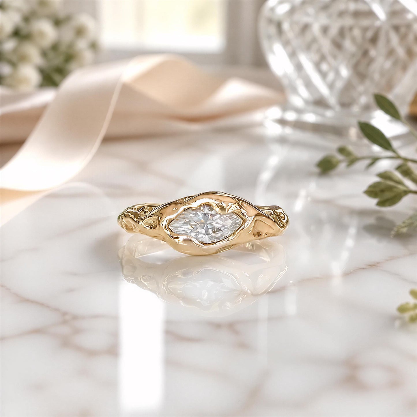 A gold ring with a large diamond set in the center, resting on a marble surface.