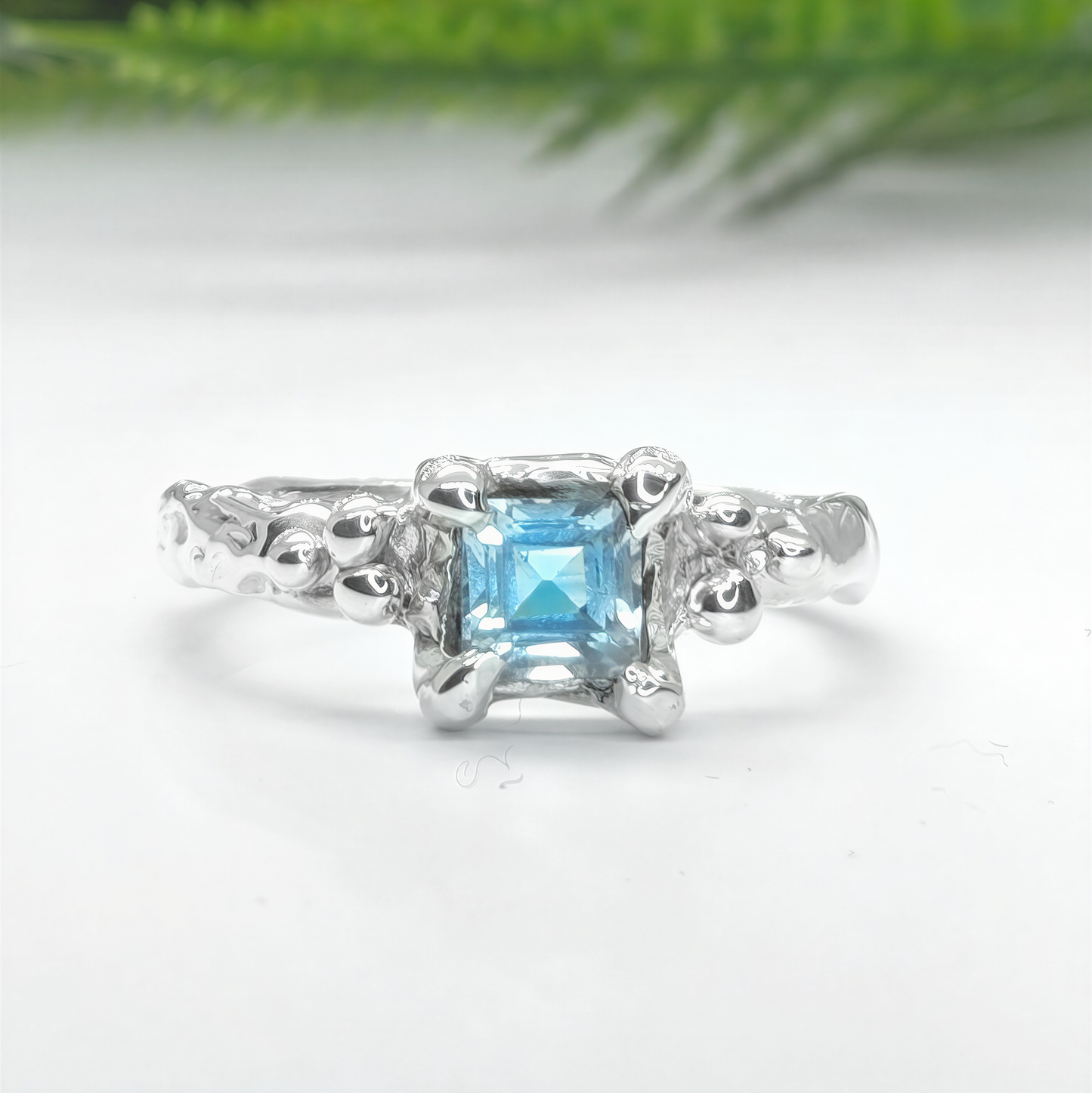 Blue Topaz engagement ring in solid sterling silver with an organic textured band.