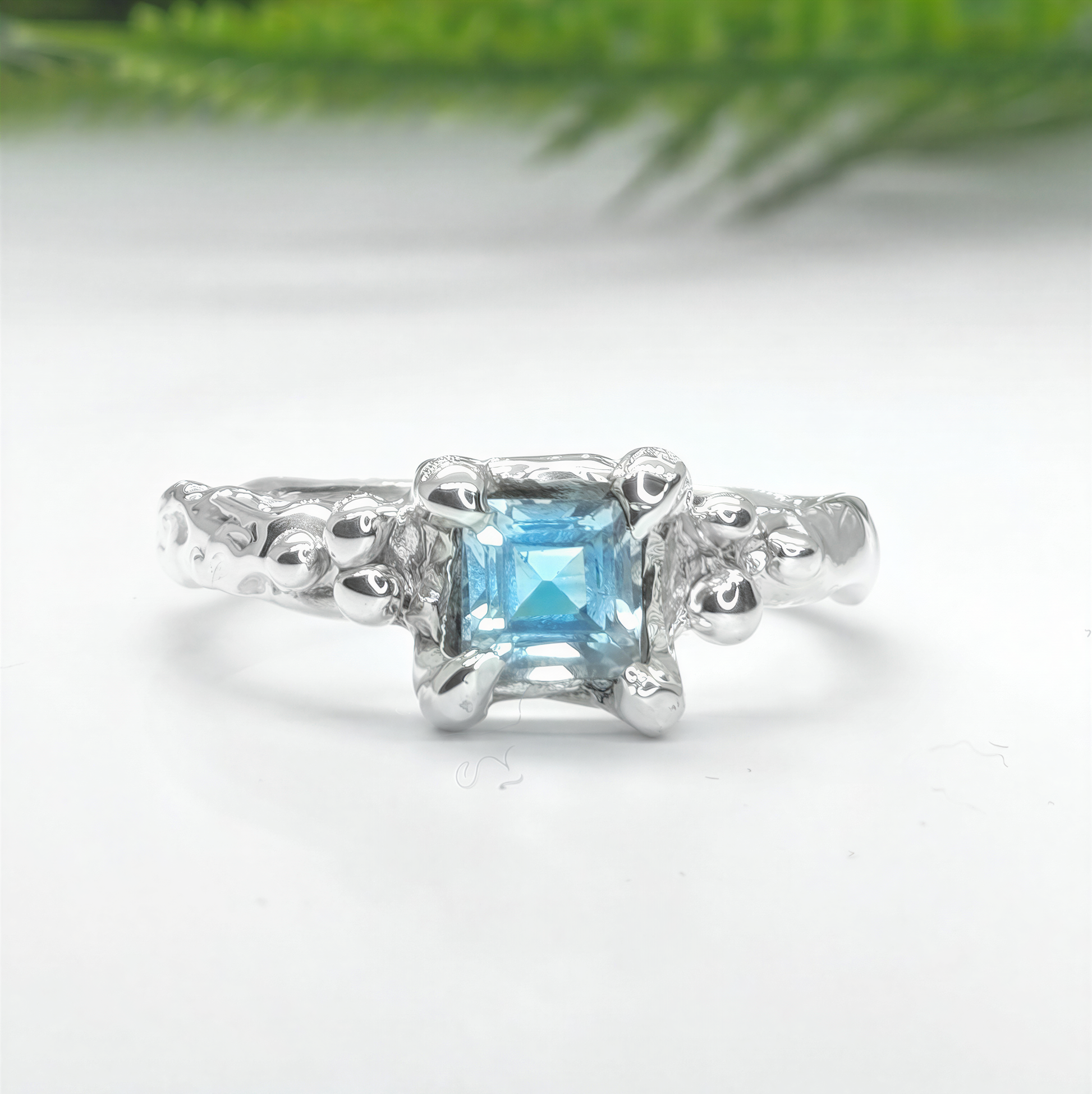 Blue Topaz engagement ring in solid sterling silver with an organic textured band.