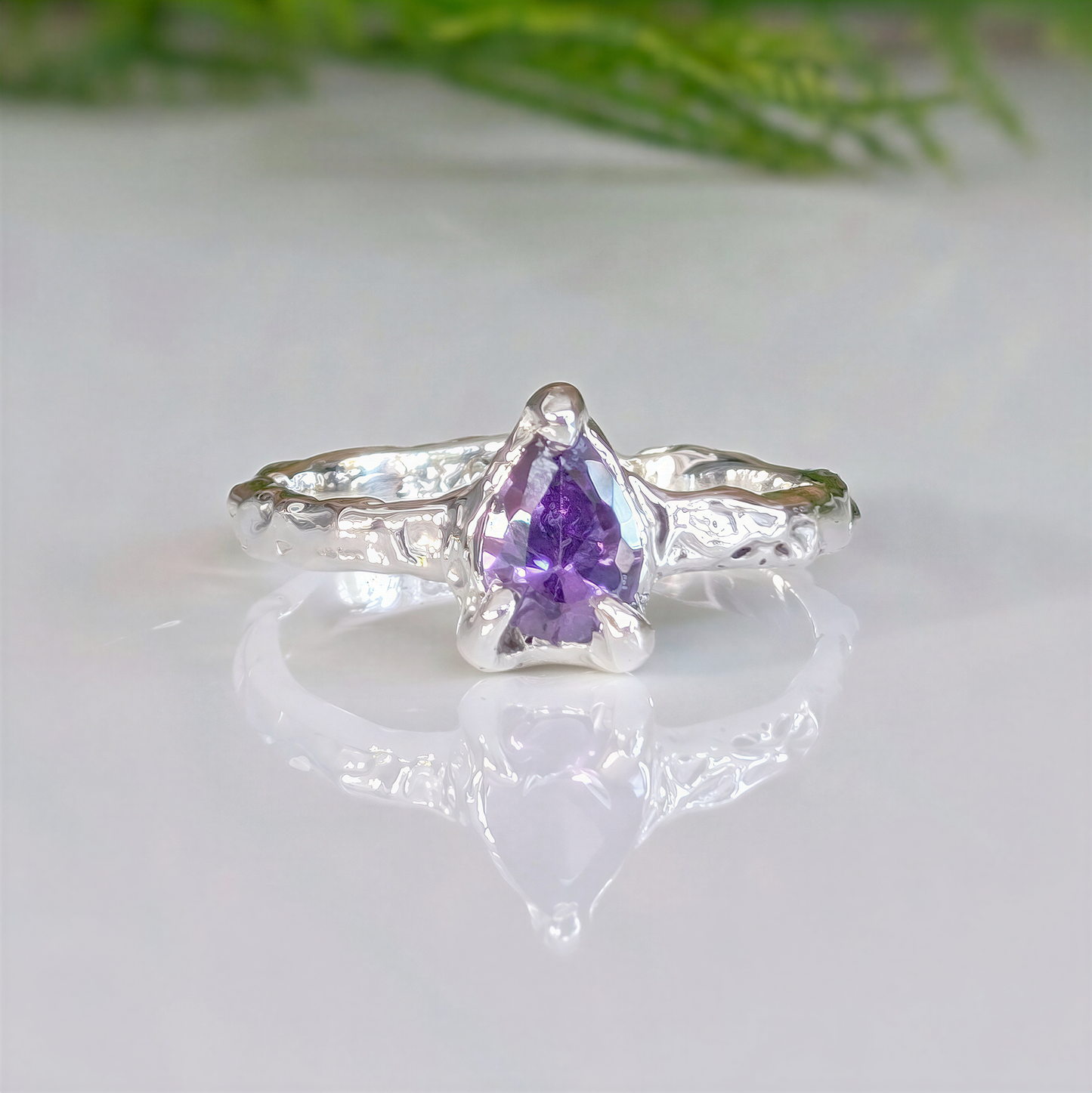 Handcrafted Amethyst engagement ring in solid sterling silver with organic textured band and pear-shaped stone.