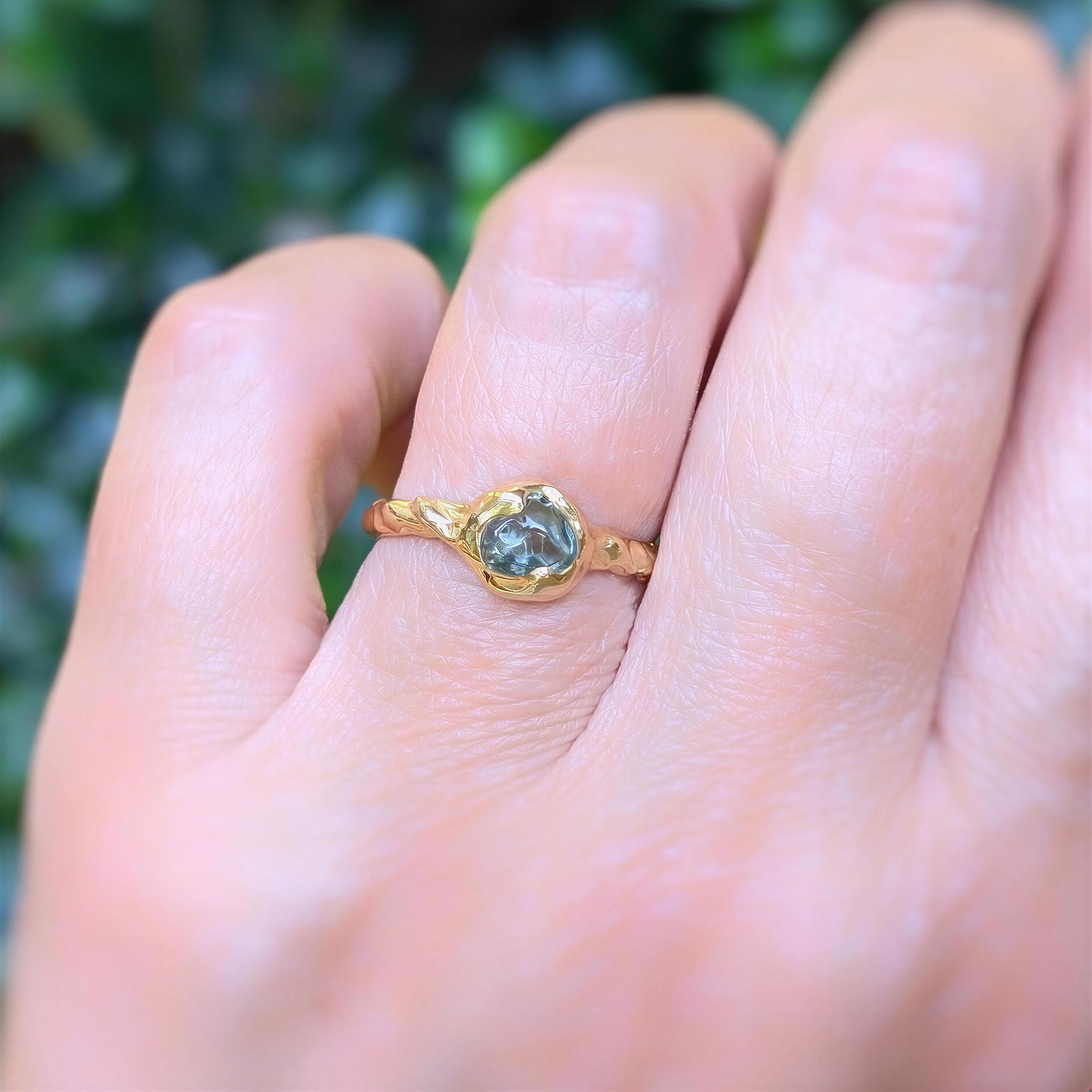 Teal Australian Sapphire ring in solid 14k gold, showcasing unique pod design on textured band.