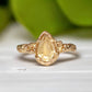 Handcrafted 14k gold Citrine ring with pear-shaped yellow crystal, featuring an organic textured band.