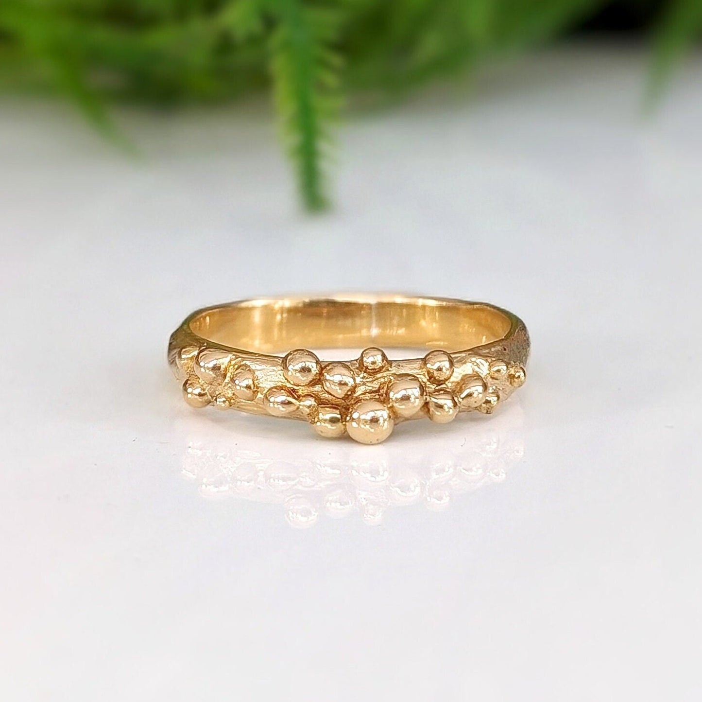 Dew Drop beaded textured gold ring showcasing its unique handcrafted design and fluid metal form.