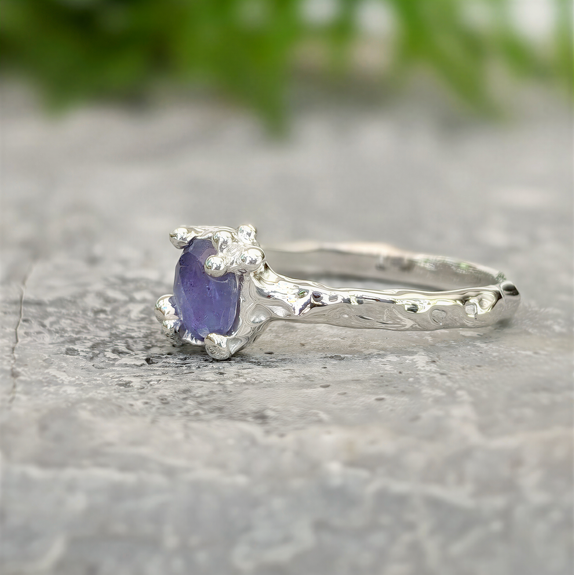 Dainty silver Tanzanite ring with organic molten band, showcasing a unique purple gemstone.