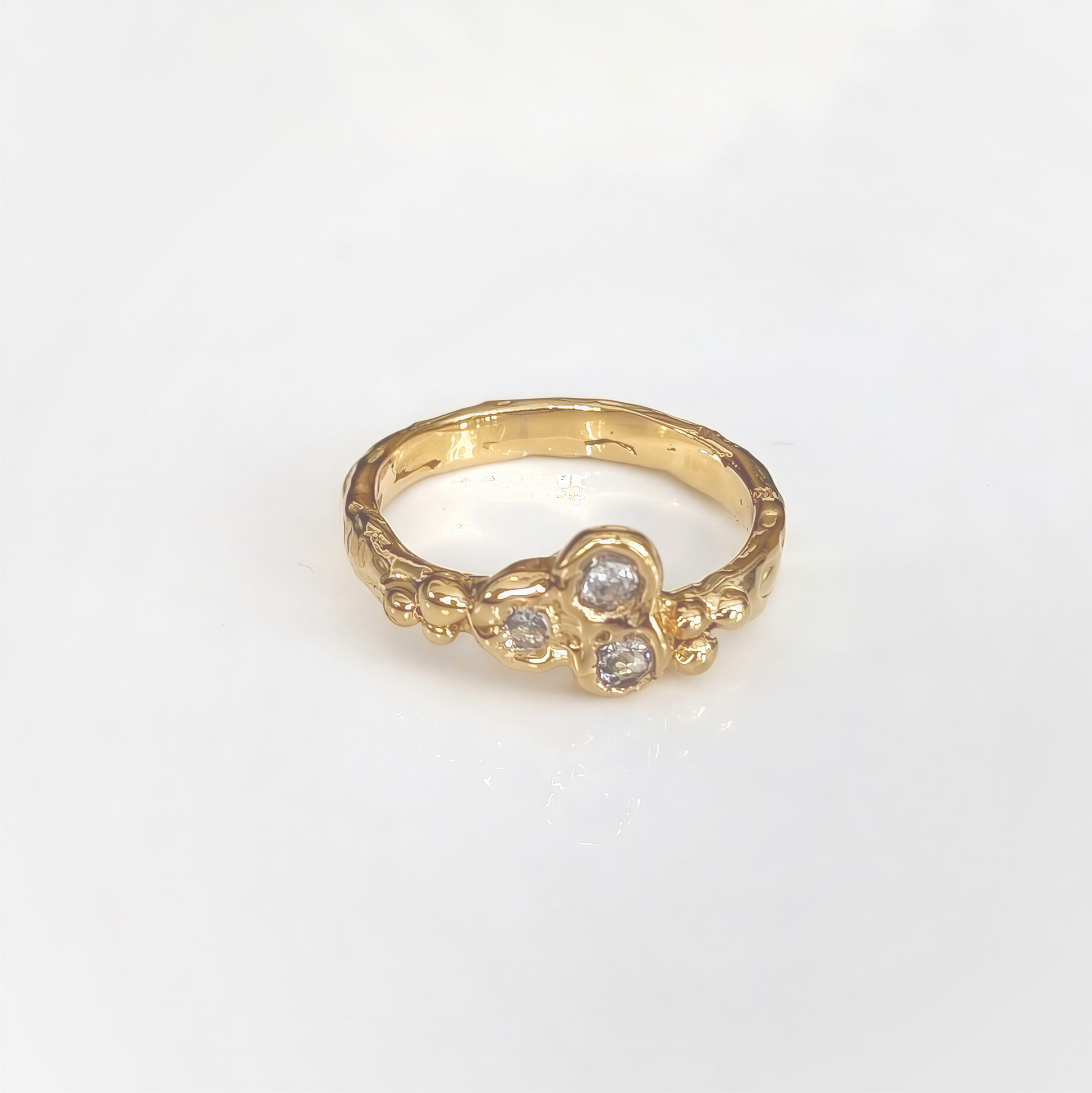 Cubic Zirconia cluster ring in solid 14k gold, featuring an organic textured band and sparkling stones.