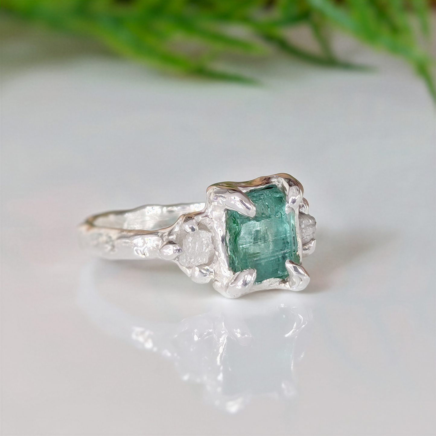 Raw emerald and diamond engagement ring in solid 14k gold, handcrafted with mint green emerald and two small raw diamonds.