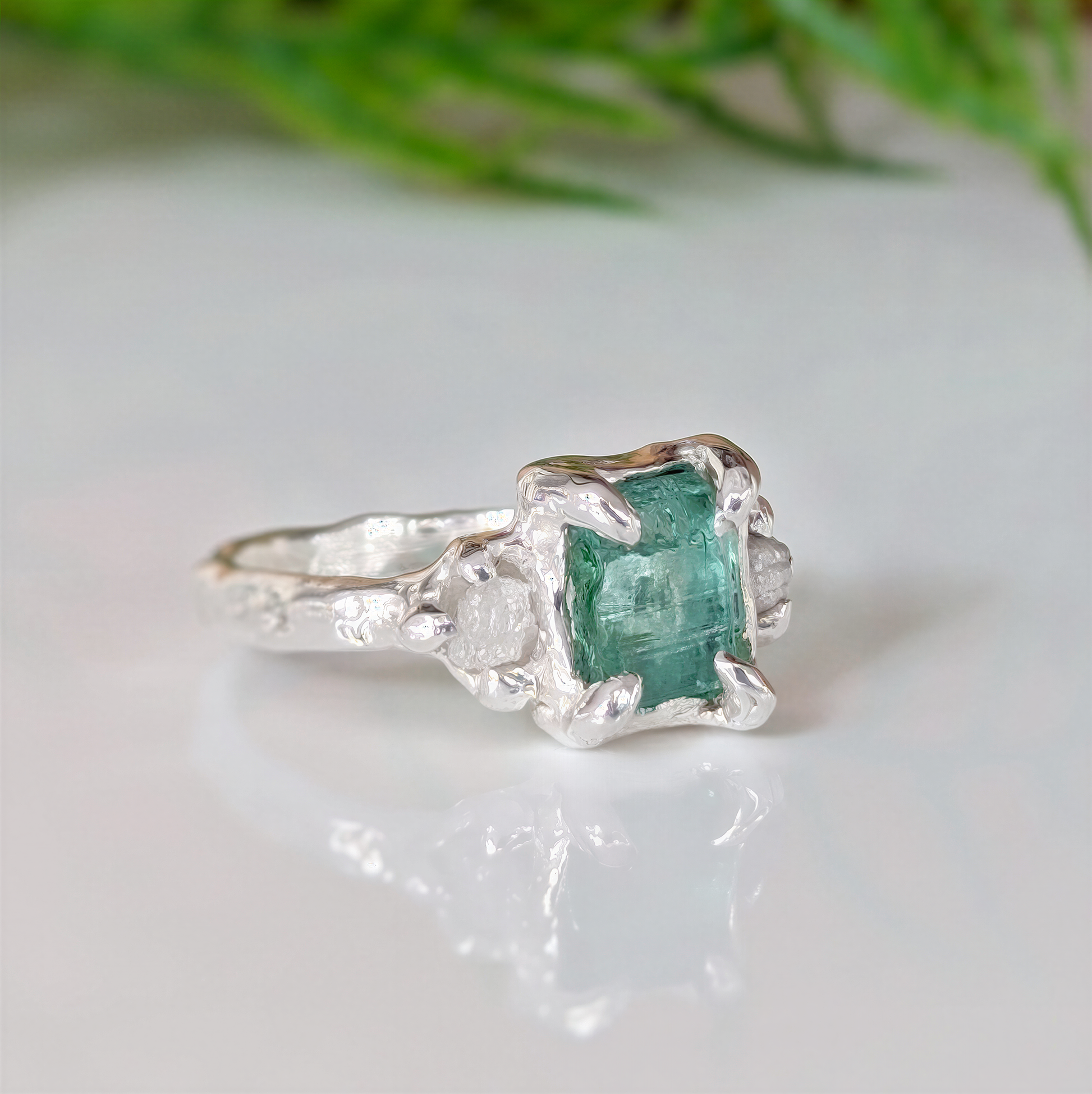 Raw emerald and diamond engagement ring in solid 14k gold, handcrafted with mint green emerald and two small raw diamonds.