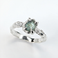 Side view of rustic silver Montana sapphire engagement ring showing organic molten textures