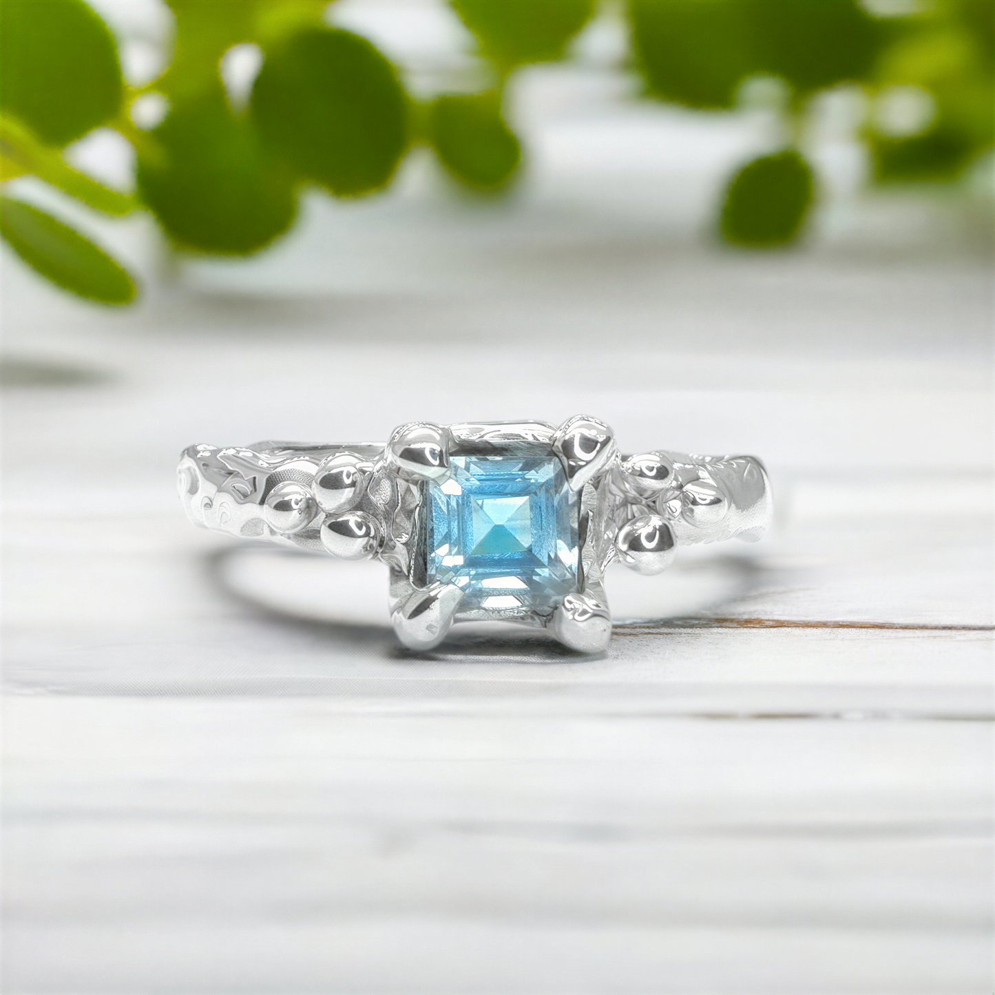 Blue Topaz engagement ring in solid sterling silver with an organic textured band for a unique and elegant look.