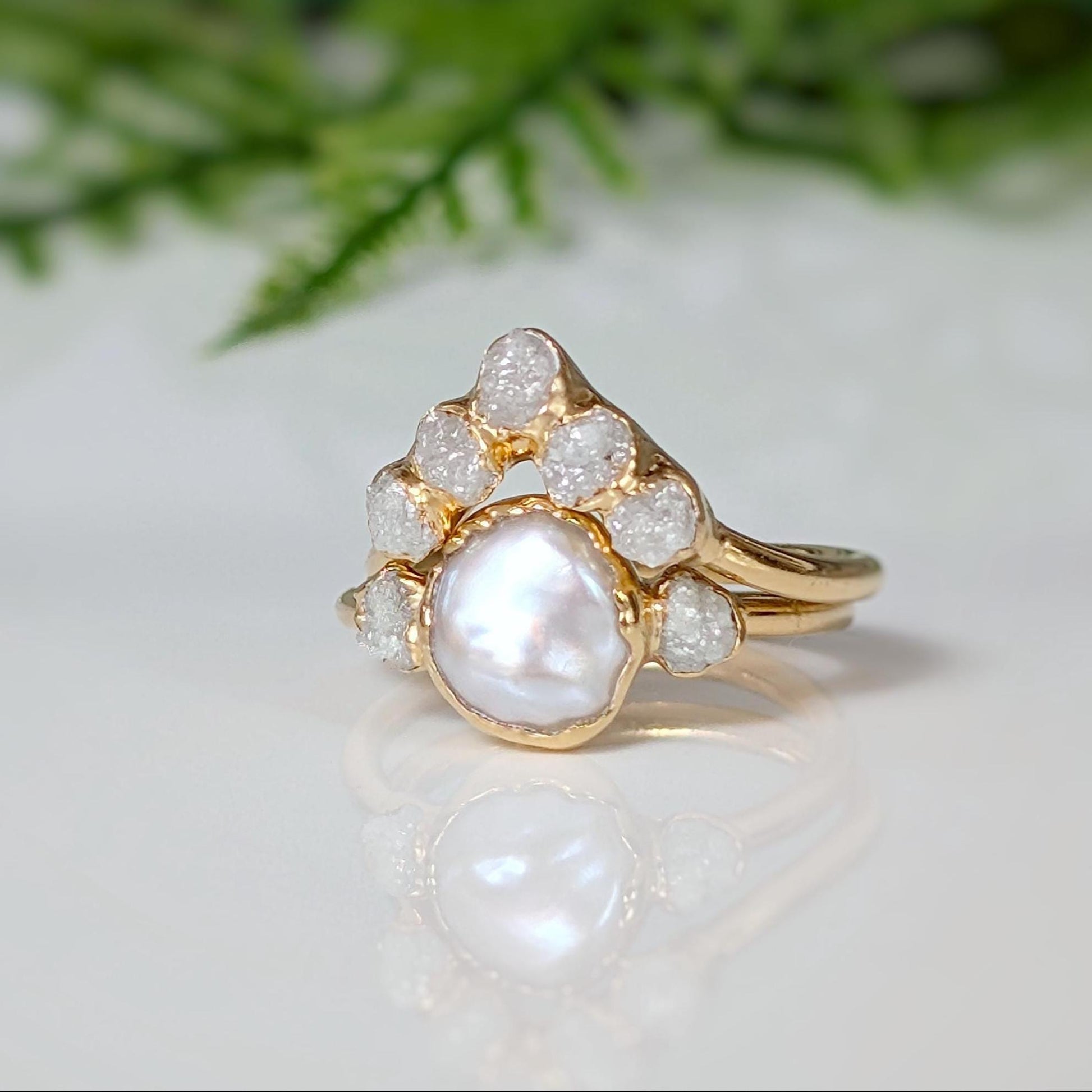 Freshwater pearl engagement ring with raw diamonds, featuring a delicate gold band and romantic design.