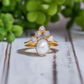 Freshwater pearl and raw diamond chevron wedding ring set in 14k gold, showcasing elegance and unique design.