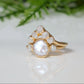 Freshwater pearl engagement ring with raw diamonds, featuring a delicate gold band and romantic design.