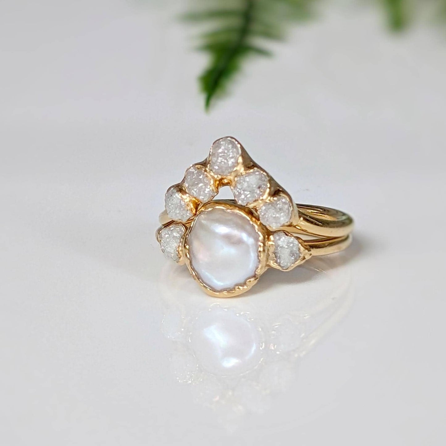 Freshwater pearl and raw diamond engagement ring with gold band, featuring rustic and romantic design.