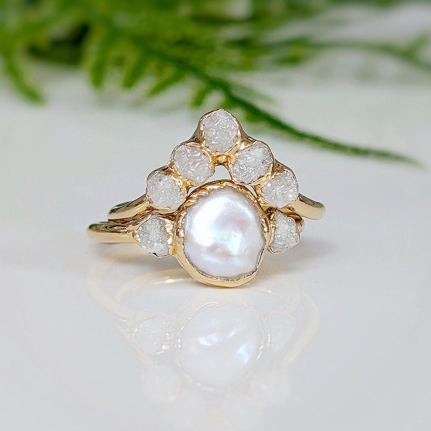 Freshwater pearl and raw diamond engagement ring featuring a creamy Keshi Pearl with rustic diamond accents.