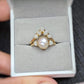 Freshwater pearl and raw diamond wedding ring set in display box showcasing rustic elegance.