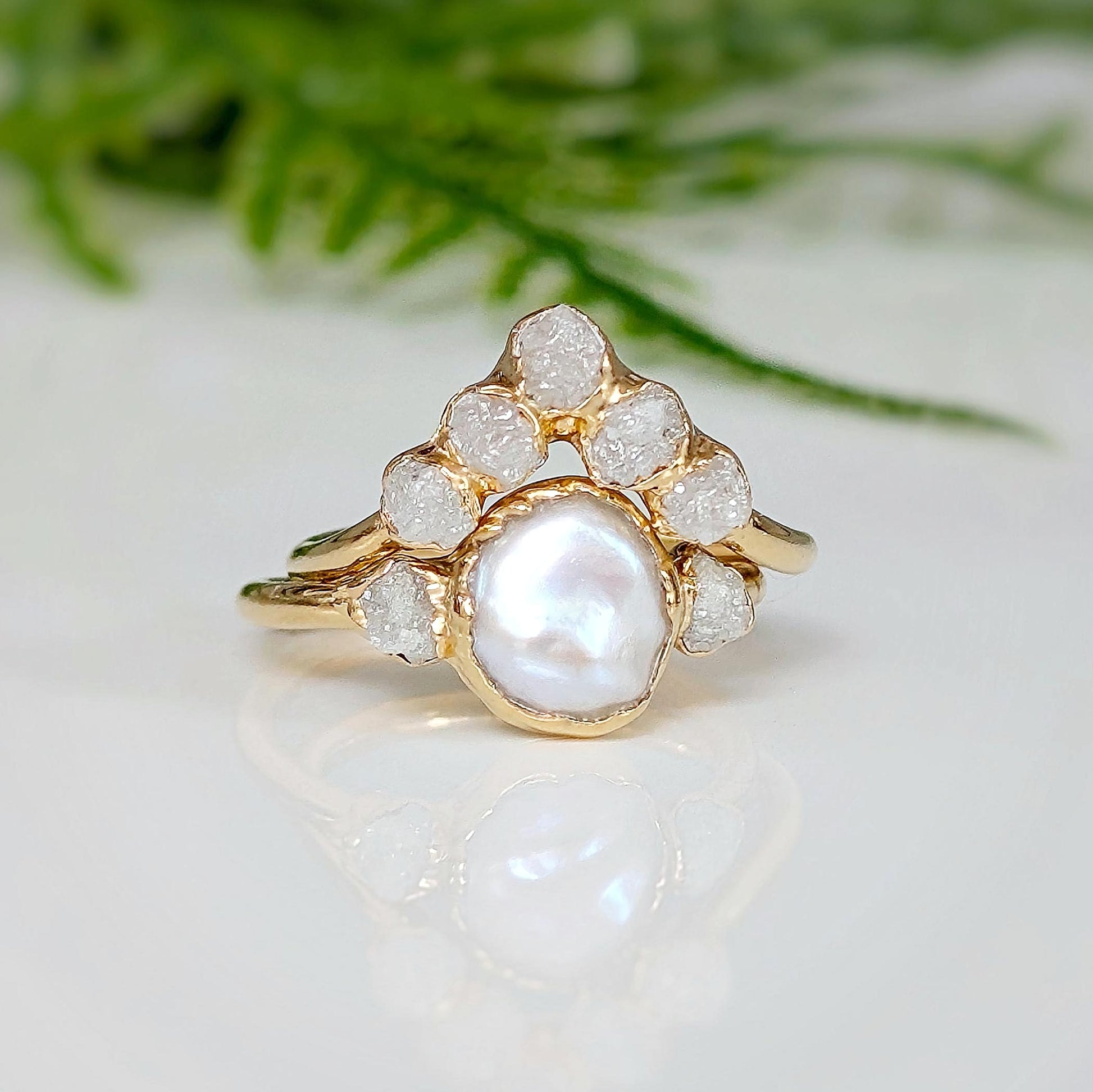Freshwater Pearl and raw diamond wedding ring set featuring a creamy Keshi Pearl and rustic diamonds on a gold band.