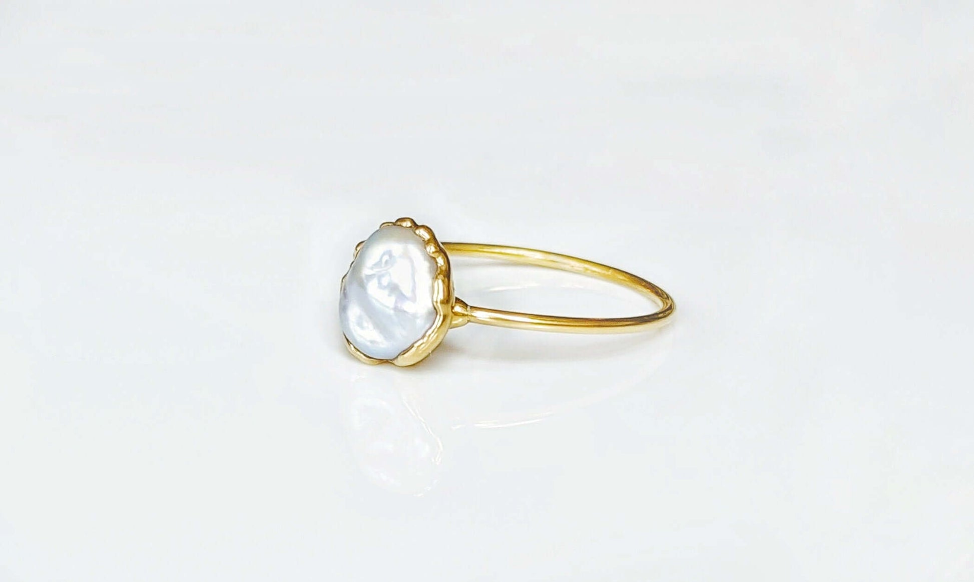 Classic Freshwater pearl ring with golden band, handcrafted June birthstone jewelry for special occasions.