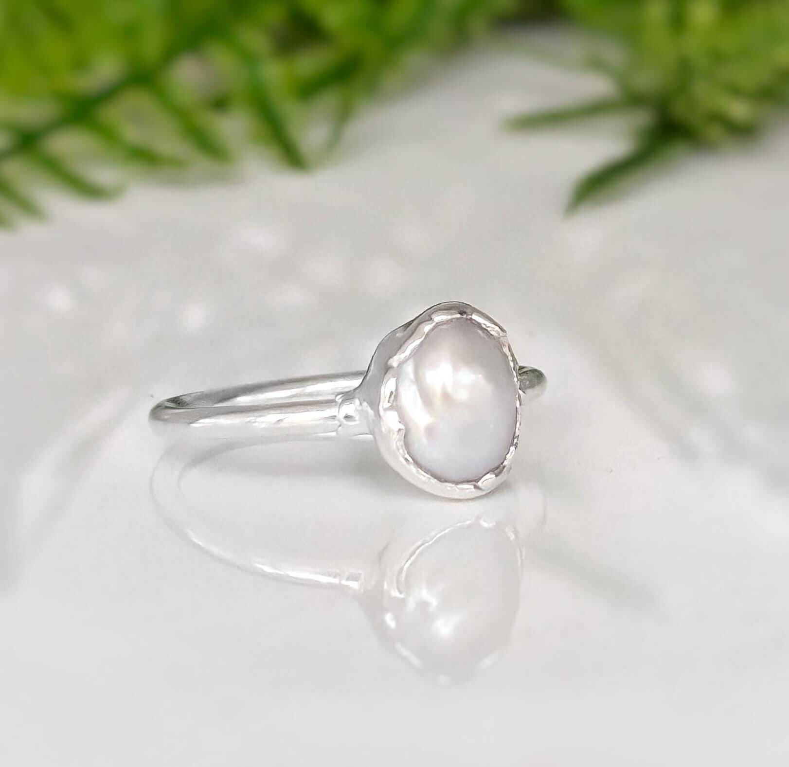Classic freshwater pearl ring featuring a creamy-white Keshi pearl on a sterling silver band.