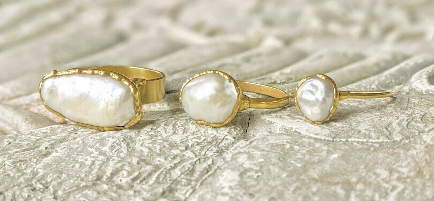 A selection of 3 Solid 14k Gold rings featuring different sizes of Freshwater Pearls