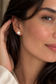 Close-up of a woman wearing a diamond earring with a blurred background