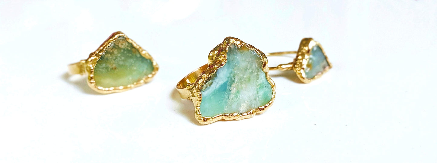 Handcrafted raw Peruvian opal rings set on 14k gold filled bands, featuring unique aqua blue stones.