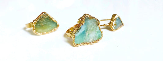 Handcrafted raw Peruvian opal rings set on 14k gold filled bands, featuring unique aqua blue stones.
