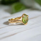 Handcrafted solid 14k gold Peridot ring with organic textured band, showcasing vibrant green crystal.