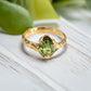 Handcrafted 14k gold Peridot ring with organic textured band, showcasing a vibrant green gemstone.