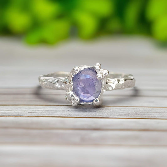 Handcrafted silver Tanzanite ring with an organic molten band, featuring a stunning purple gemstone.
