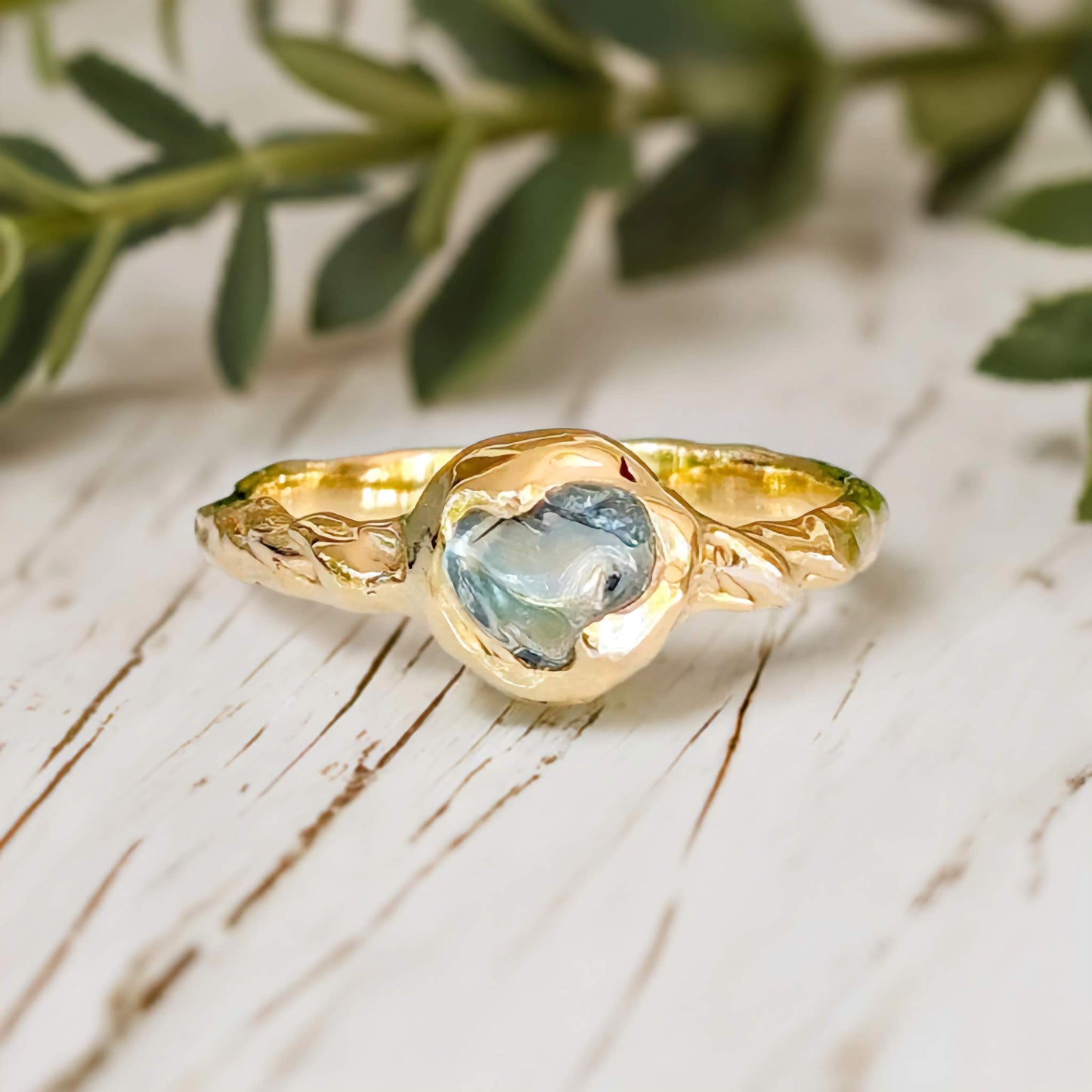 Teal Australian Sapphire ring in solid 14k gold from the "Pea in a Pod" collection, featuring a textured band.