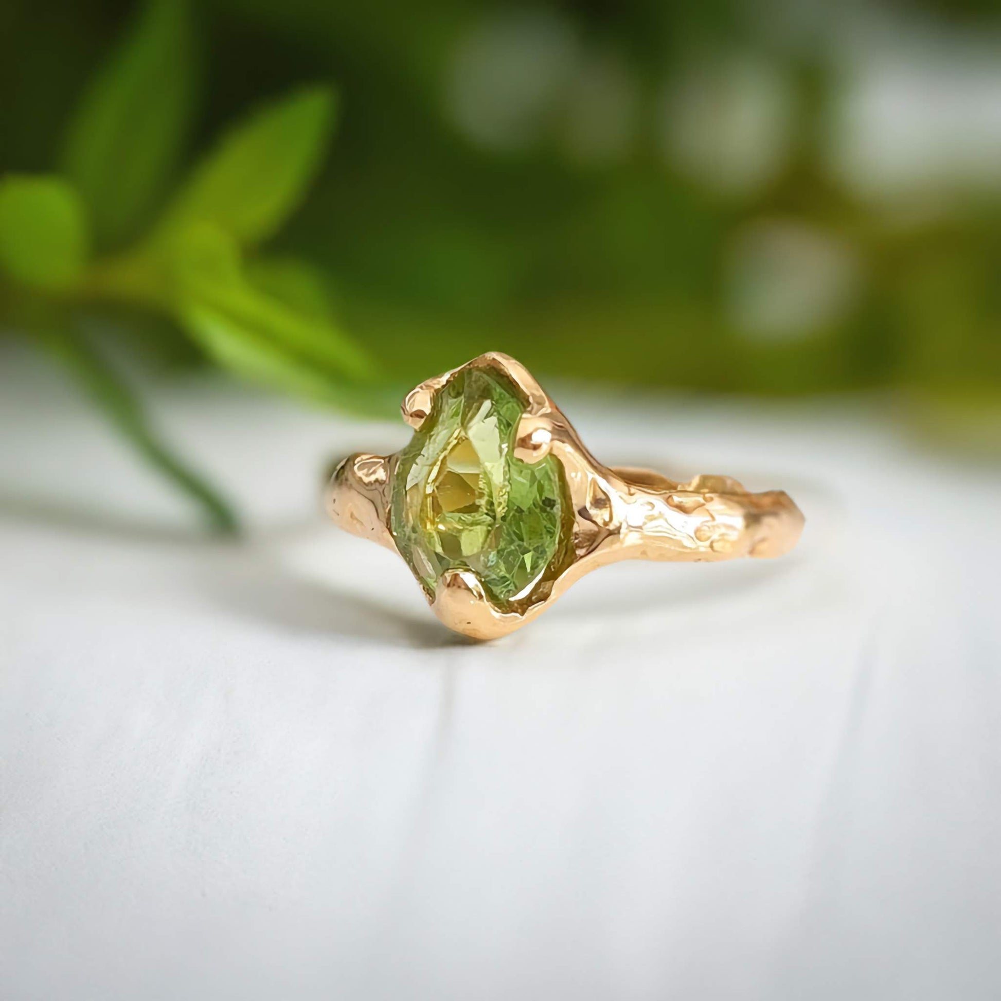 Handcrafted Peridot ring set in solid 14k gold with an organic textured band, showcasing its unique green crystal.