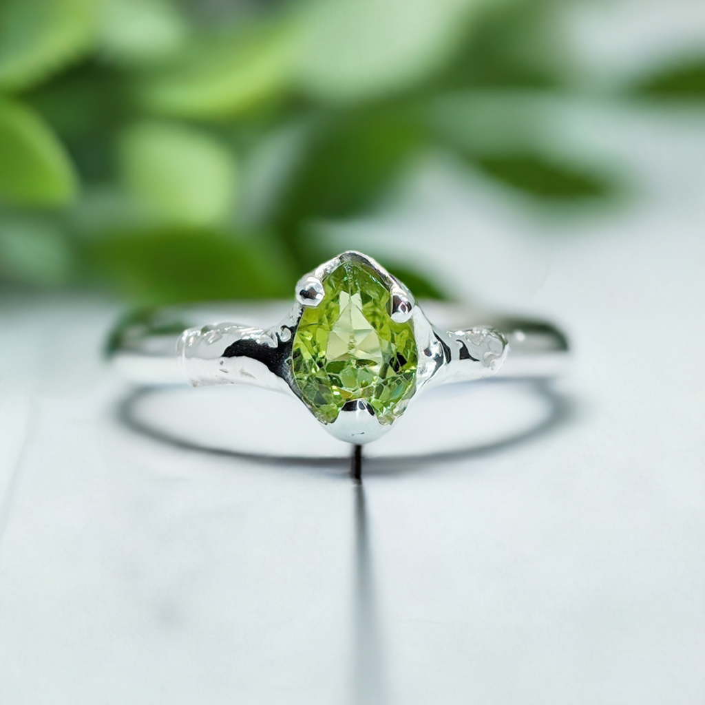 Handcrafted Peridot sterling silver ring with organic textured band, showcasing a vibrant green gemstone.