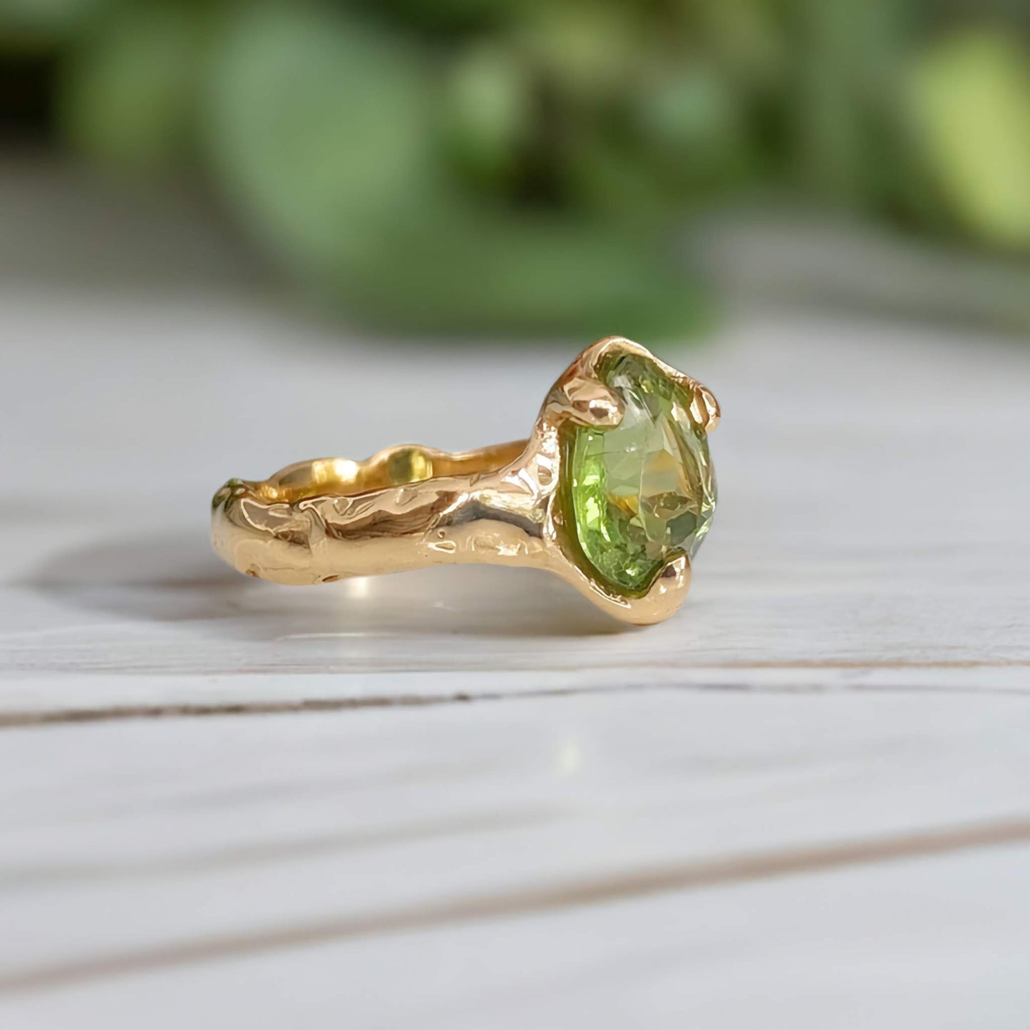 Handcrafted Peridot ring in solid 14k gold with organic textured band, showcasing a radiant green crystal.