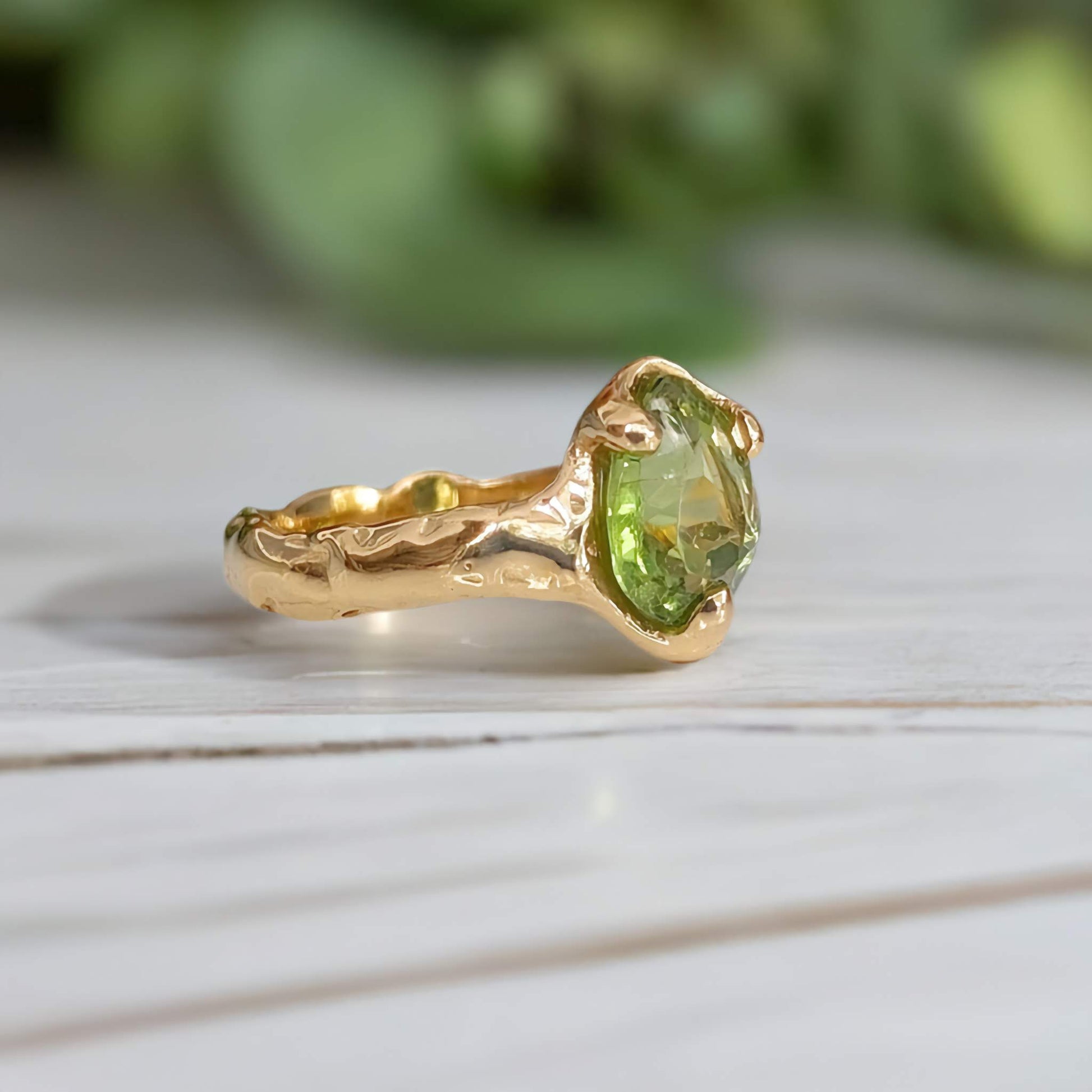 Handcrafted Peridot ring in solid 14k gold with organic textured band, showcasing a radiant green crystal.