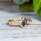 Teal Australian Sapphire ring in textured solid 14k gold from the 'Pea in a Pod' collection, showcasing natural beauty.
