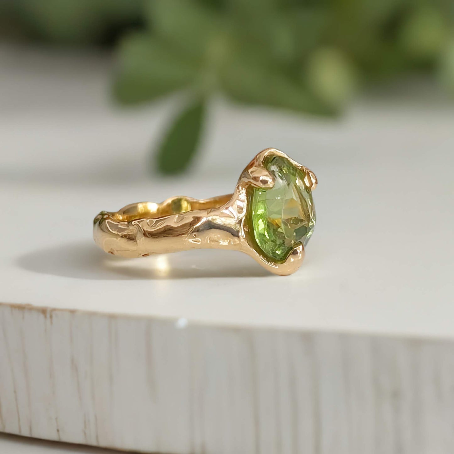 Solid 14k Gold peridot ring with organic textured band, handcrafted and featuring a stunning green crystal.