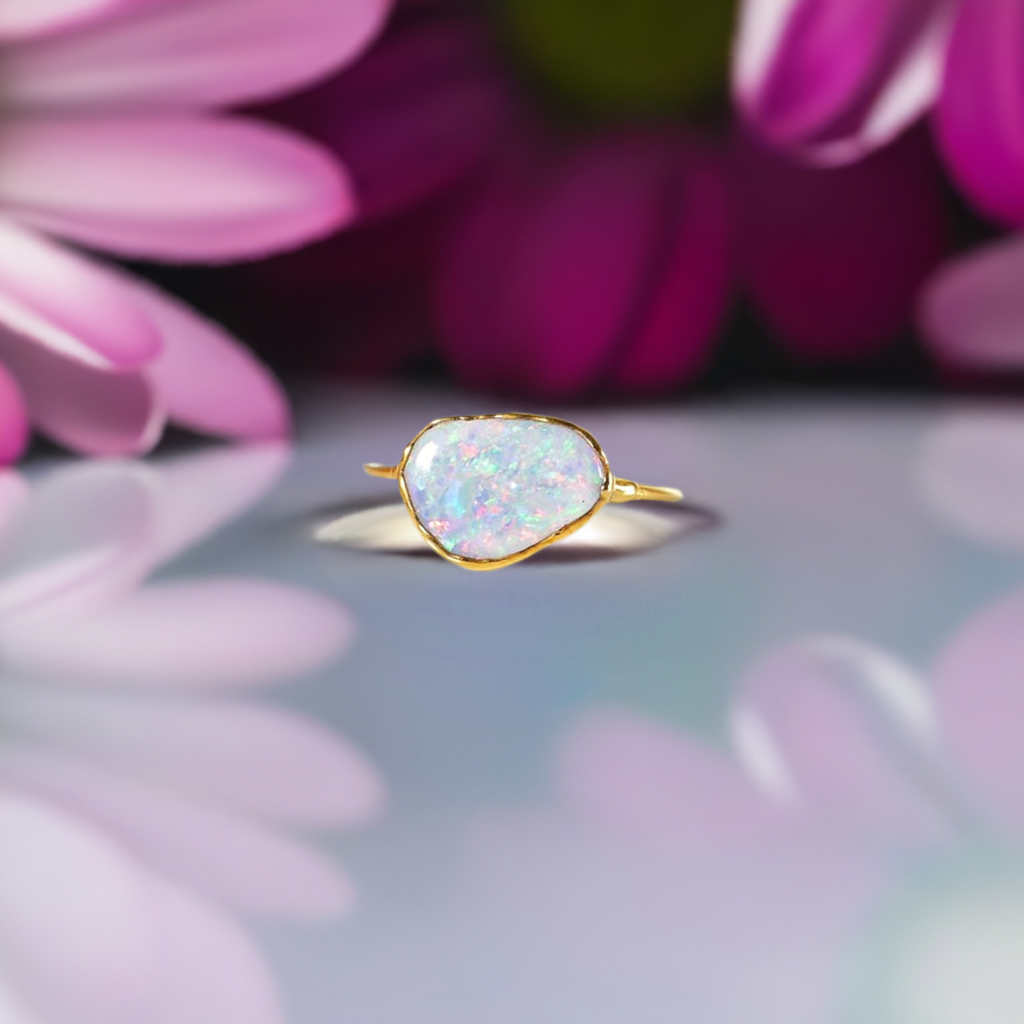 Handcrafted Australian Opal ring set on a 14k Gold filled band, framed by vibrant floral petals.