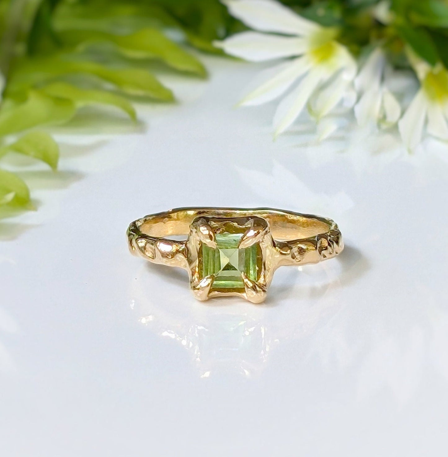 Solid silver Peridot ring with organic textured band, featuring a princess-cut gemstone in a unique design.