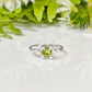 Handcrafted solid silver ring featuring a princess-cut Peridot, surrounded by an organic textured band, perfect for engagements.